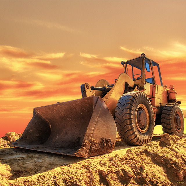 Front Loader Parked In The Sunset